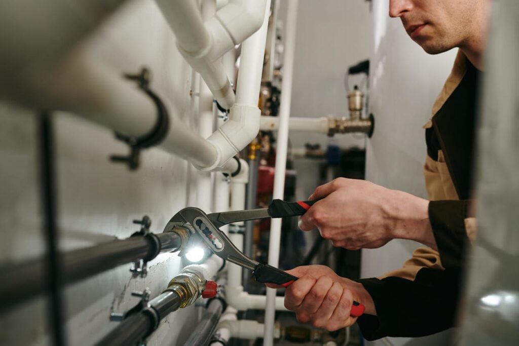 Plumbers maintaining commercial plumbing pipes in Murray