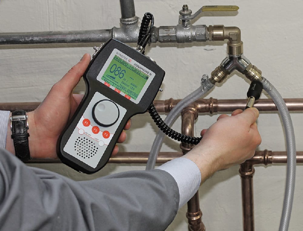 Plumber testing pipes with electronic leak detection equipment in Murray