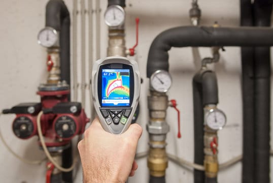 Plumber using a thermal imaging camera to inspect pipes in Murray
