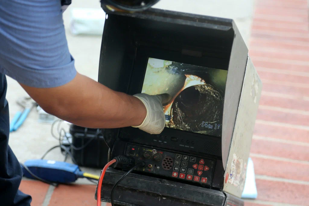 Technician viewing a drain inspection camera in Murray