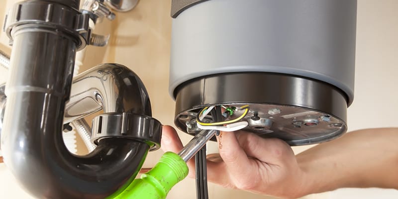 Technician repairing the heating element of a water heater in Murray