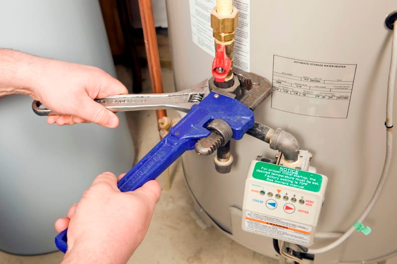 Plumber repairing a water heater valve in Murray
